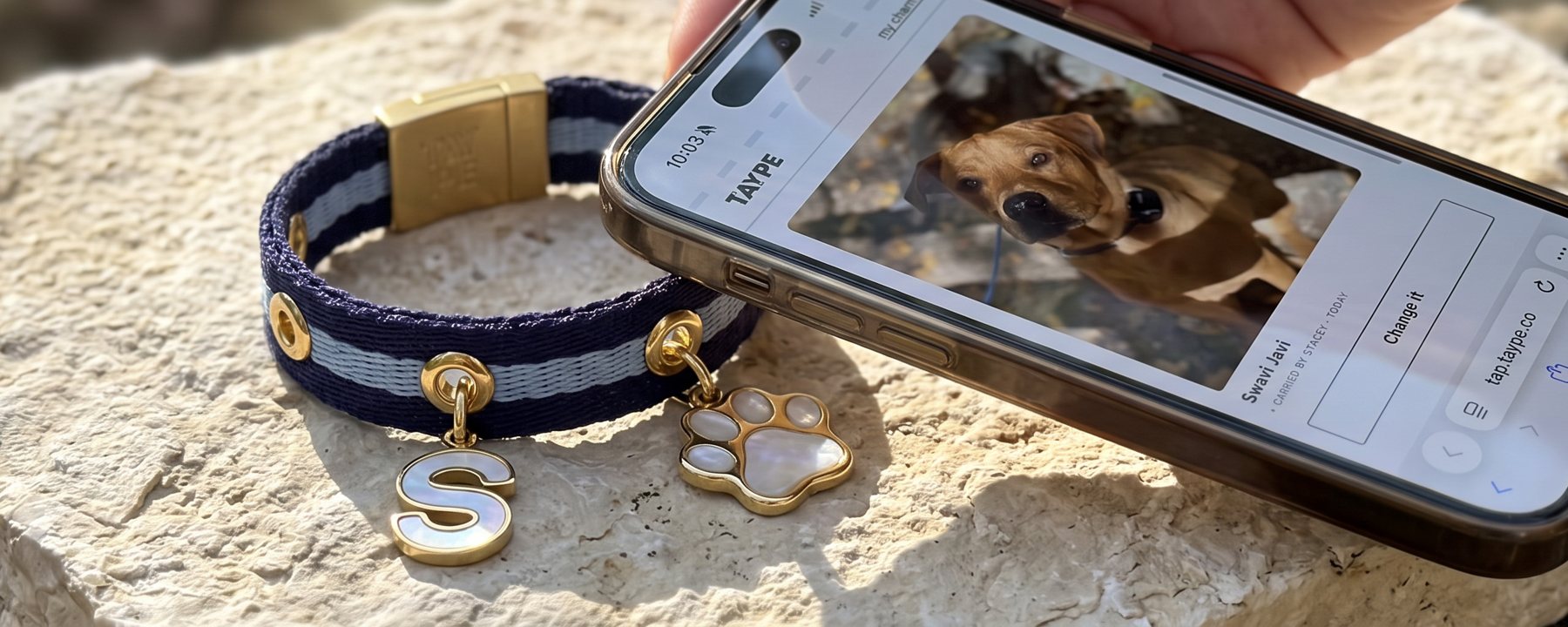 A woven Taype band with collectible charms beside a phone showing a story